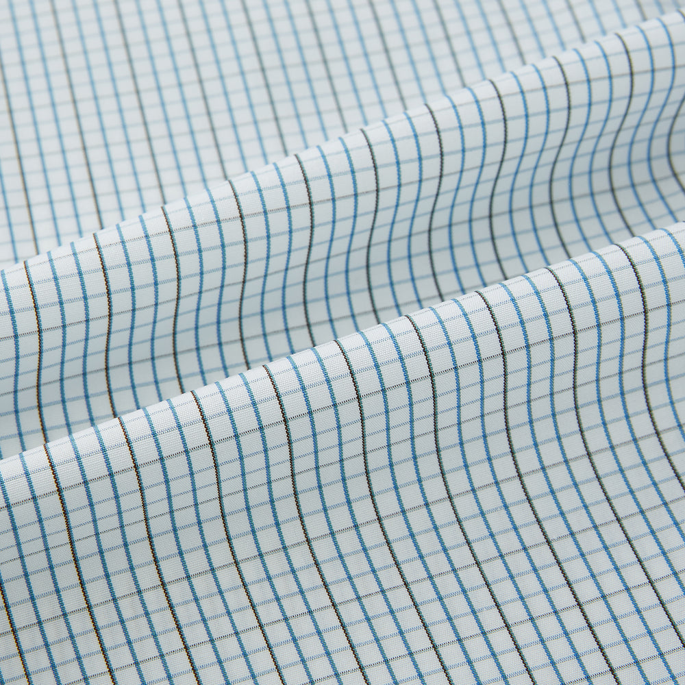 The Pale Blue and Navy Grid Check Westminster Shirt by Turnbull & Asser features a button-down front and pointed collar, highlighting fine British craftsmanship, displayed on a white background.