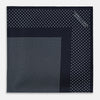 View 3 of product The Turnbull & Asser Navy and Light Blue Dot Silk Pocket Square features white polka dots, a contrasting border, and an inner square design, showcasing handmade craftsmanship with its expertly folded finish.