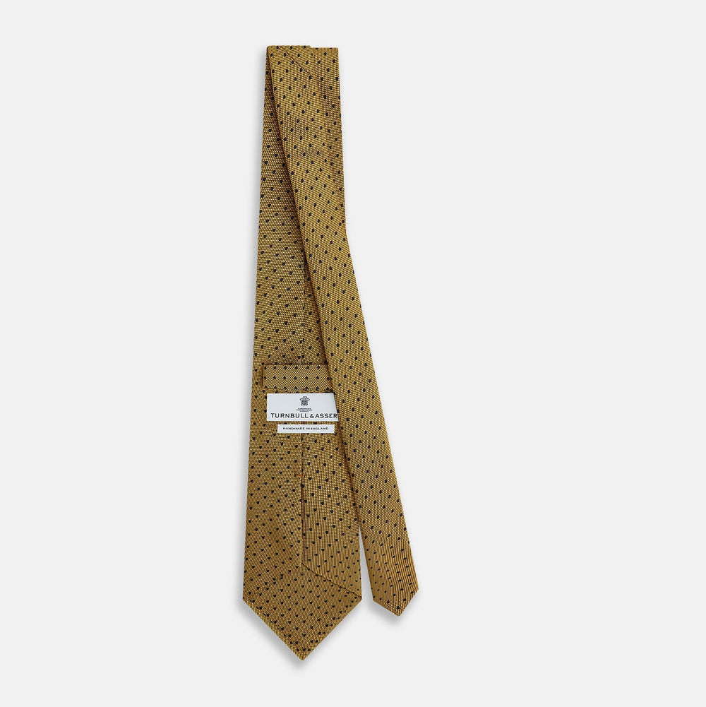 The Turnbull & Asser Purple and Yellow Micro Dot Silk Tie, featuring a refined micro-dot pattern, is a timeless men's accessory.