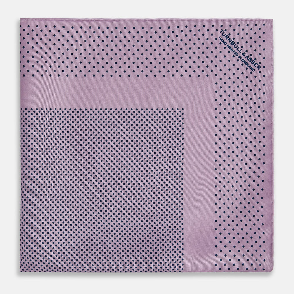 The Lilac Dot Silk Pocket Square by Turnbull & Asser is handmade from silk in a folded design, featuring small black polka dots and a solid border.