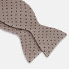 View 3 of product The Turnbull & Asser Navy and Taupe Micro Dot Silk Bow Tie features a grid pattern with small dots, shown against a plain white background.