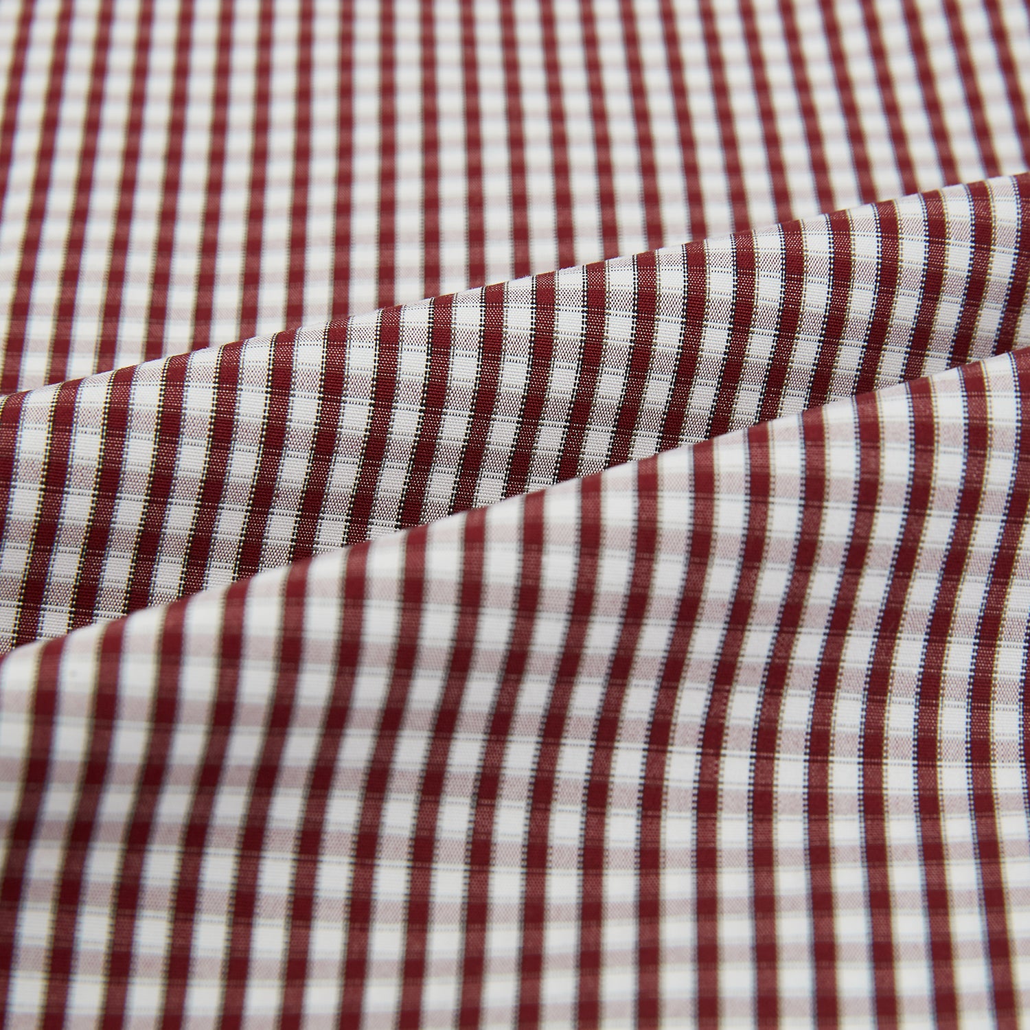 View 5 of product The Turnbull & Asser Burgundy Micro Check Winston Long Nightshirt is knee-length with long sleeves, brown and white micro checks, a collar, chest pocket with piping, and a front button placket.
