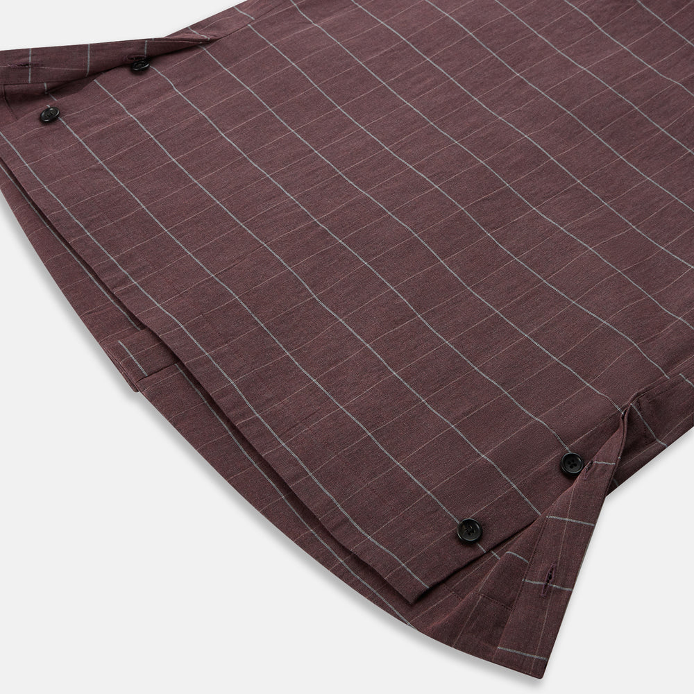 The Turnbull & Asser Burgundy Check Hampstead Overshirt, featuring a button-up front, collar, white windowpane pattern, and two front pockets, is laid flat on a white background—perfect for elegant formal wear.