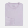View 4 of product The Turnbull & Asser Lilac Cashmere Round Neck Jumper for men features long sleeves with ribbed cuffs and hem, offering a stylish, refined look. Shown against a white background.