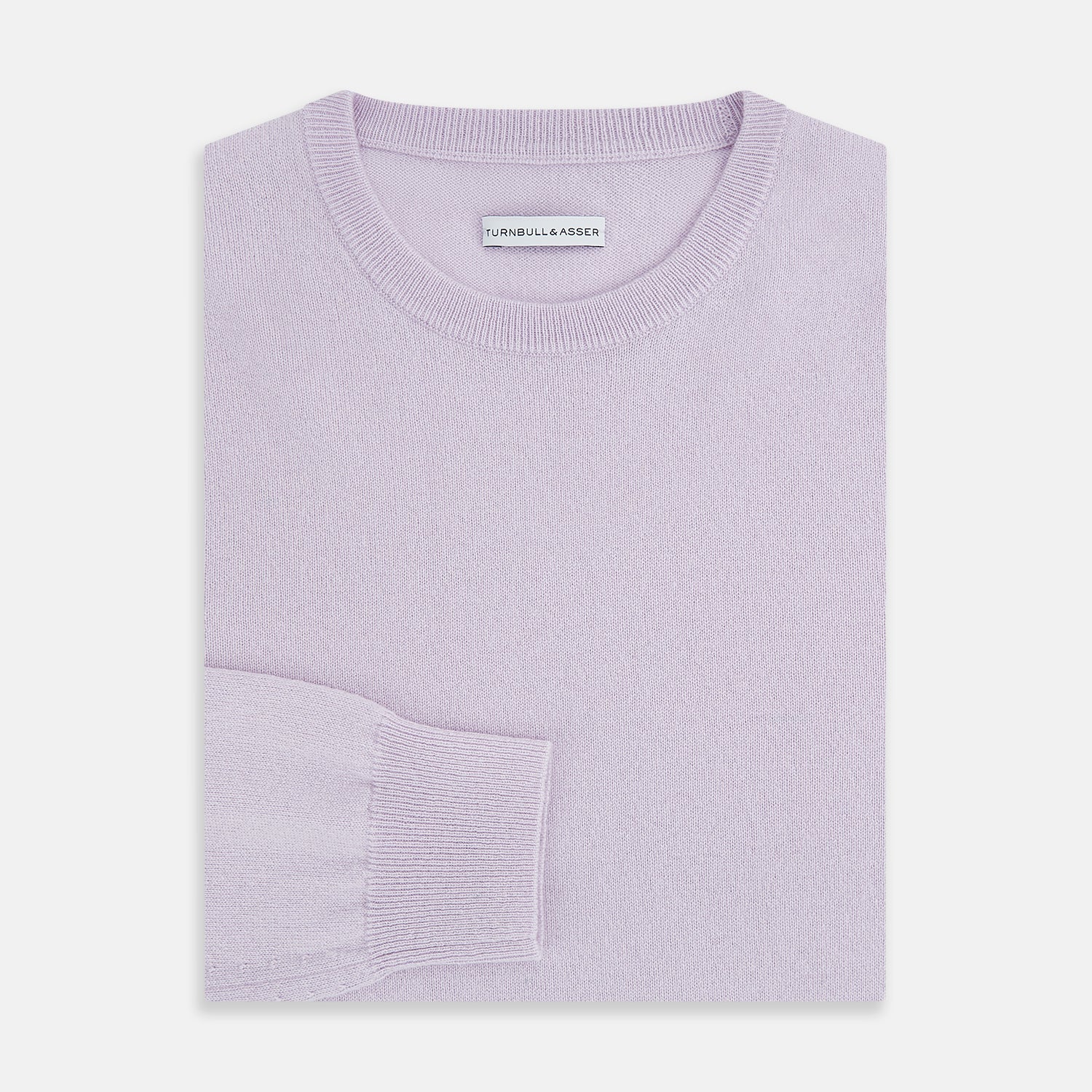 View 4 of product The Turnbull & Asser Lilac Cashmere Round Neck Jumper for men features long sleeves with ribbed cuffs and hem, offering a stylish, refined look. Shown against a white background.