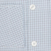 View 4 of product The Turnbull & Asser Blue Graph Check Pyjama Shirt features long sleeves, a collar, and a small check pattern in light blue—ideal as elegant loungewear.