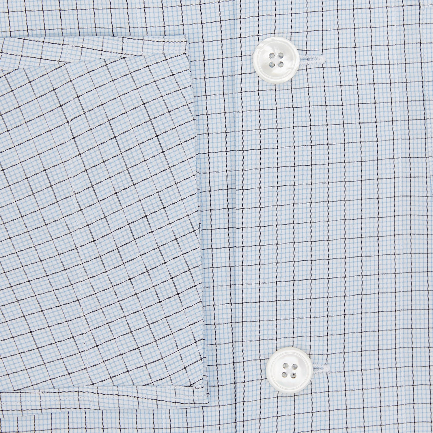 View 4 of product The Turnbull & Asser Blue Graph Check Pyjama Shirt features long sleeves, a collar, and a small check pattern in light blue—ideal as elegant loungewear.