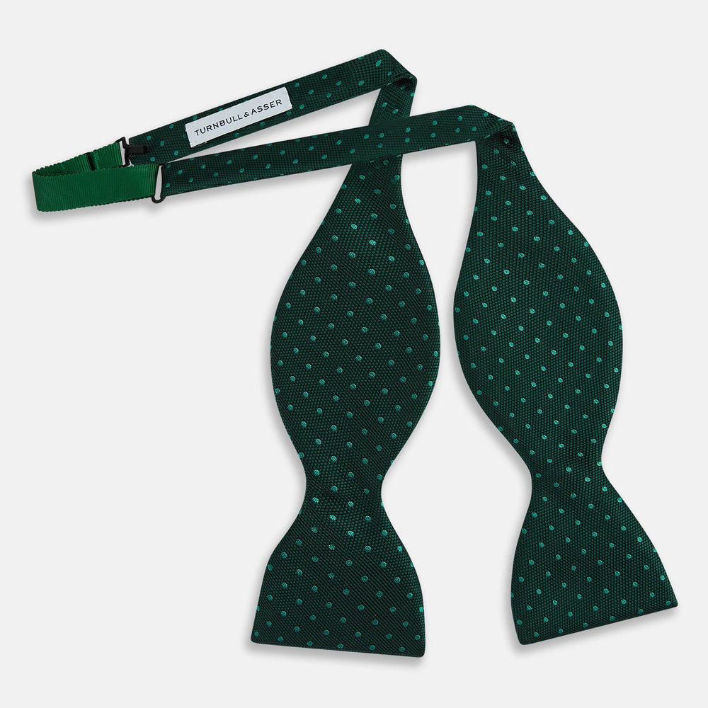 The Turnbull & Asser Turquoise and Forest Green Micro Dot Silk Bow Tie features small light green spots on a dark background, offering a stylish accessory for any occasion.