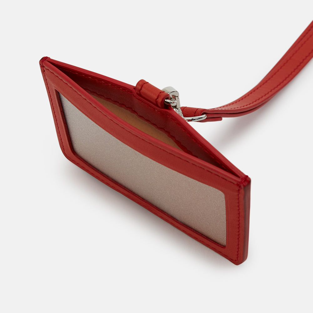 The Red ID Card Holder by Turnbull & Asser is crafted from Italian leather with a matching lanyard and a small key charm. The brand’s name is embossed in white on the front for an elegant finish.