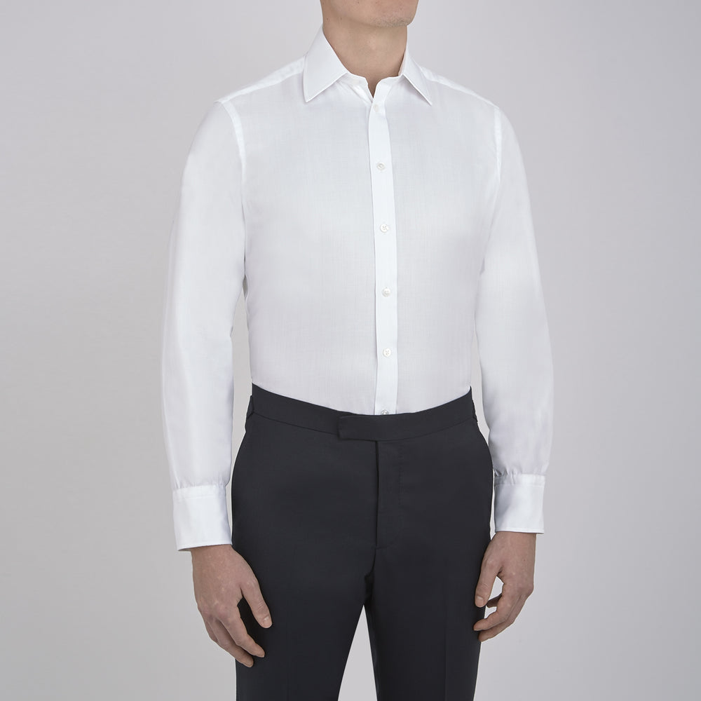 The Turnbull & Asser White Herringbone Superfine Cotton Shirt with T&A collar and 3-button cuffs is perfect for pairing with statement ties or elevating minimalist looks.