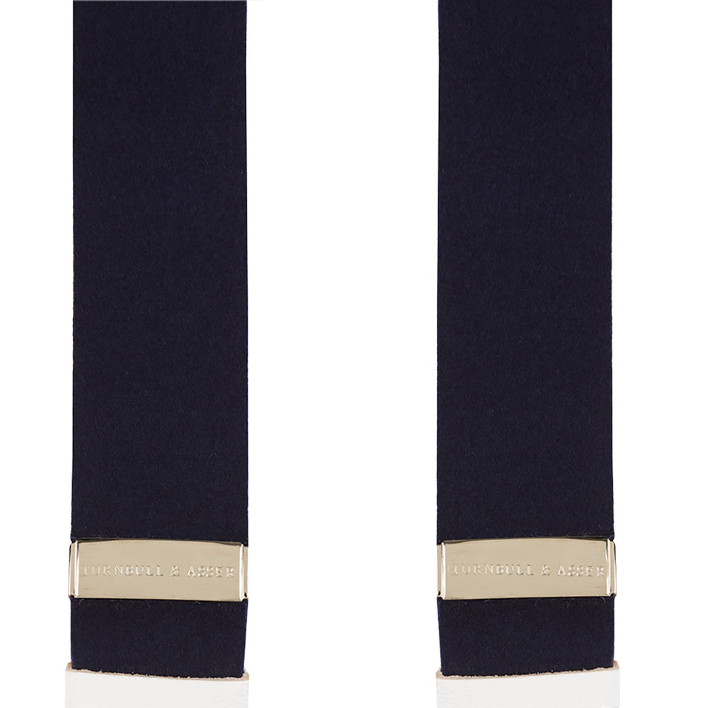 A pair of Turnbull & Asser Navy Adjustable Felt Braces, featuring pure wool boxcloth, white leather button loops, and gold-toned metal details, shown vertically on a plain white background. Expertly crafted in England for timeless style.