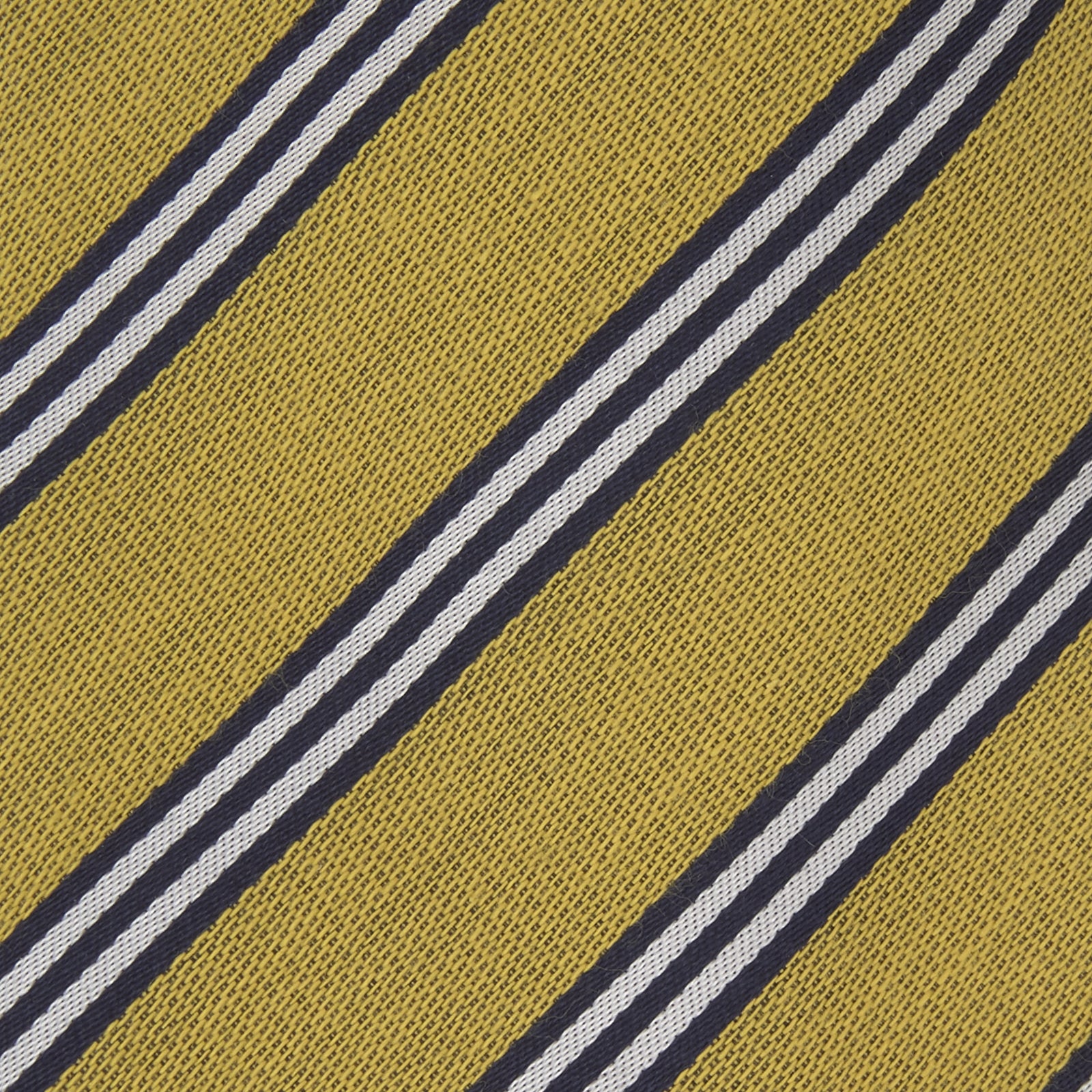 View 3 of product The Turnbull & Asser GGT92000 3042 11 OS is a classic yellow necktie with diagonal black and white stripes, rolled elegantly on a white background.