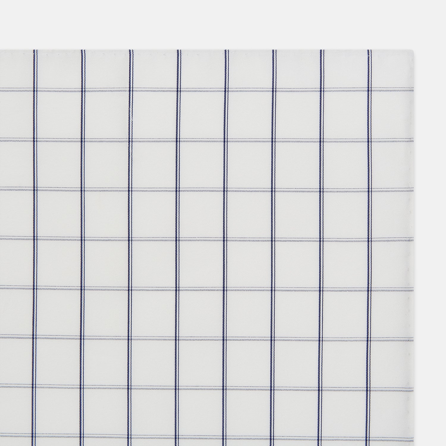 View 3 of product The Turnbull & Asser Dark Navy Double-Line Check Hand-Rolled Handkerchief features a white base with intersecting navy lines and hand-rolled edges, expertly crafted in England.