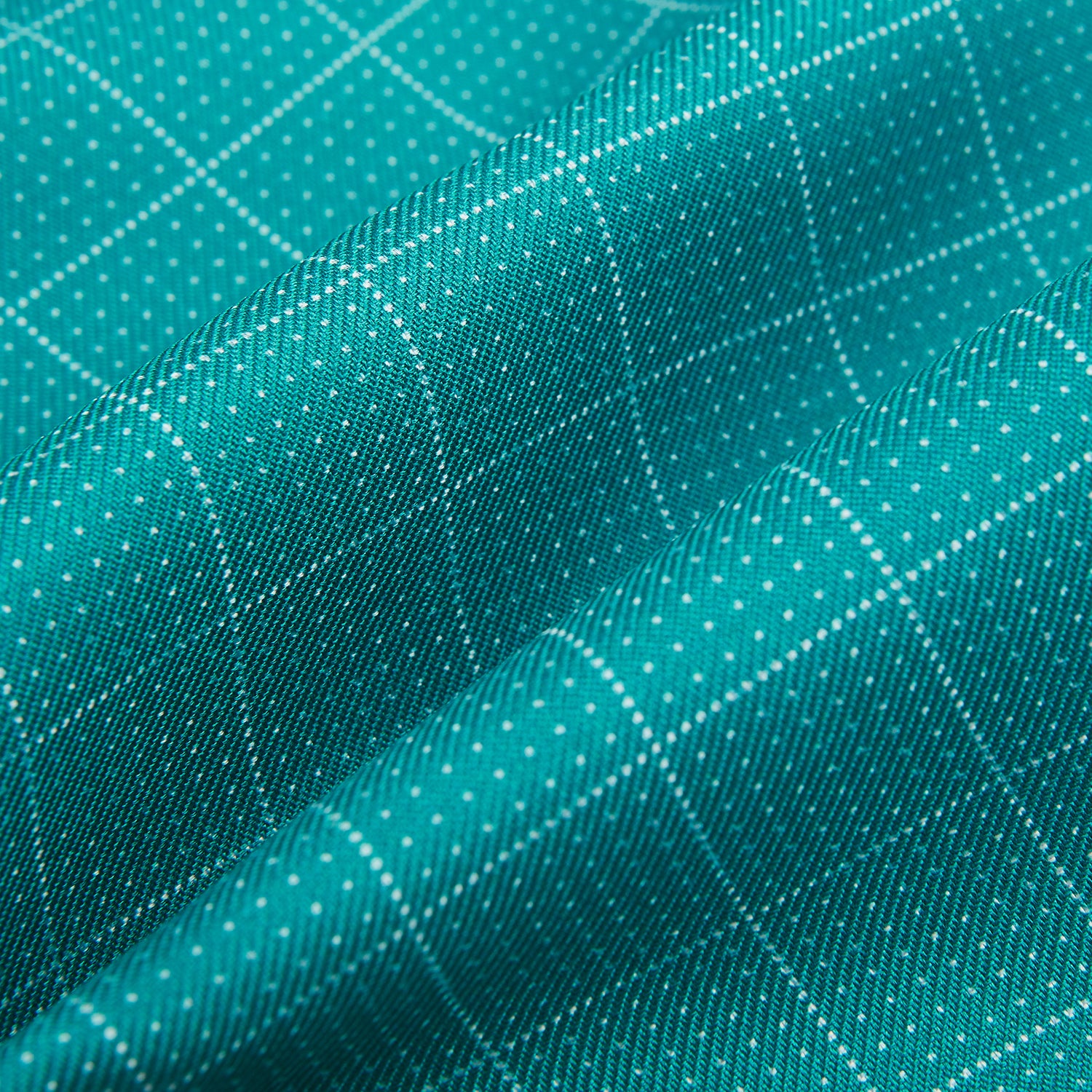 View 4 of product The Turquoise Dotted Check Pattern Printed Silk Cravat by Turnbull & Asser features a neatly folded diamond shape and a refined white dotted grid, showcasing classic style.