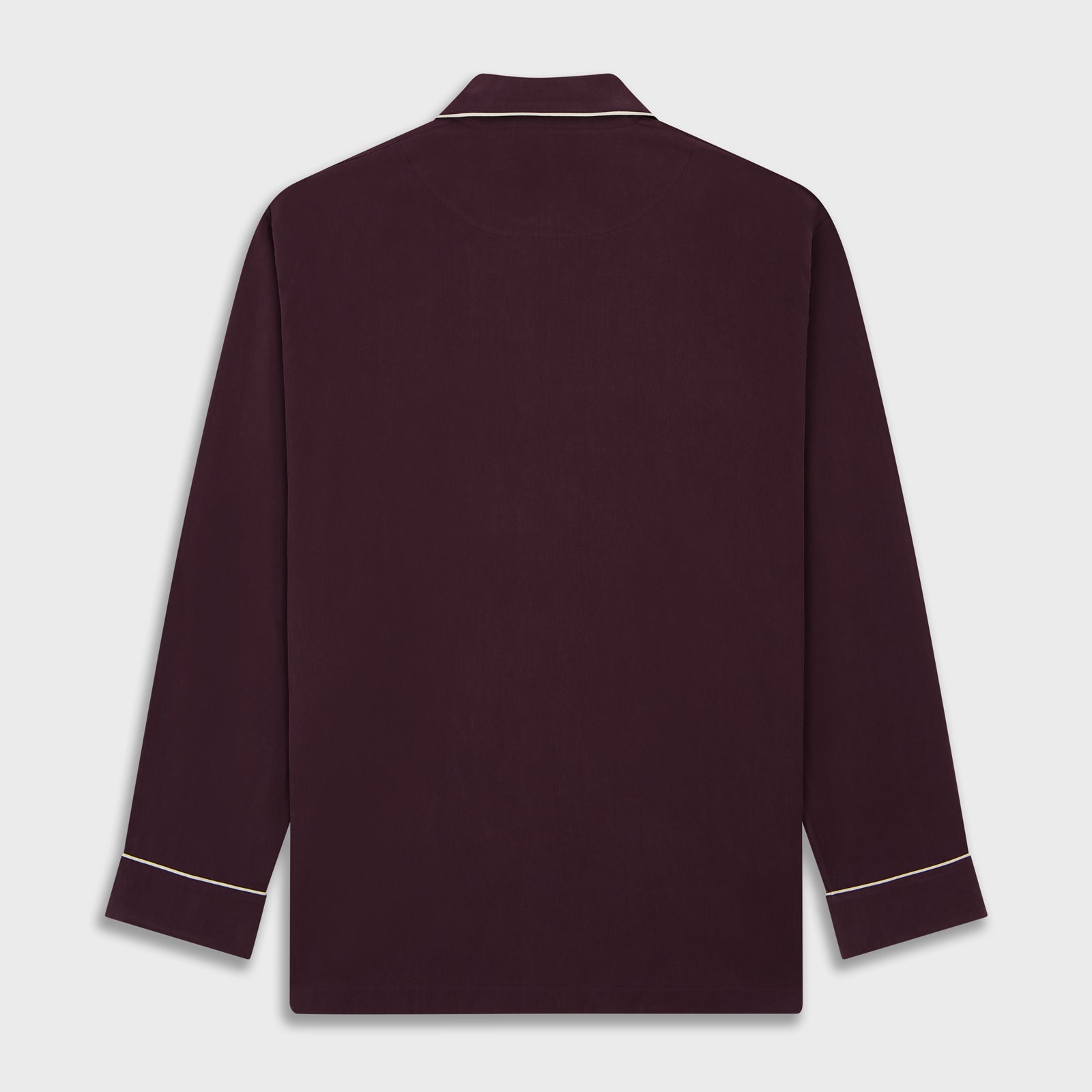 View 5 of product The Turnbull & Asser Plain Plum Silk Modern Pyjama Set, made in England, features white piping, a button-up long-sleeve top with three pockets, and matching pants. The pyjamas are shown against a white background.