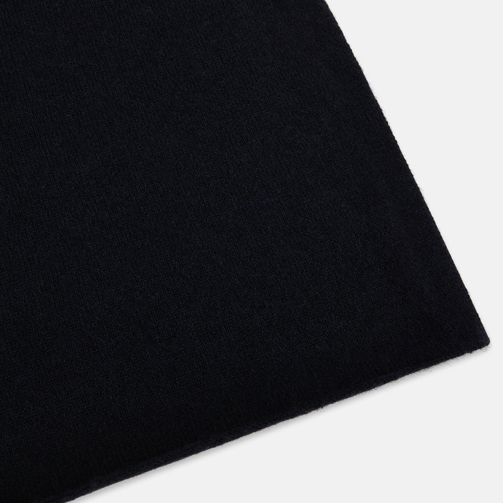 The Turnbull & Asser Plain Navy Cashmere Knitted Scarf is shown looped against a white background, highlighting its soft texture and elegant drape.