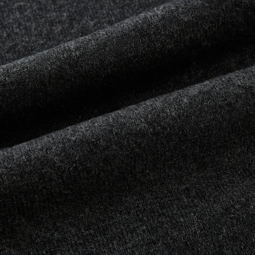 The Turnbull & Asser Plain Charcoal Cashmere Knitted Scarf, shown tied simply against a white background, is a classic luxury accessory perfect for any wardrobe.