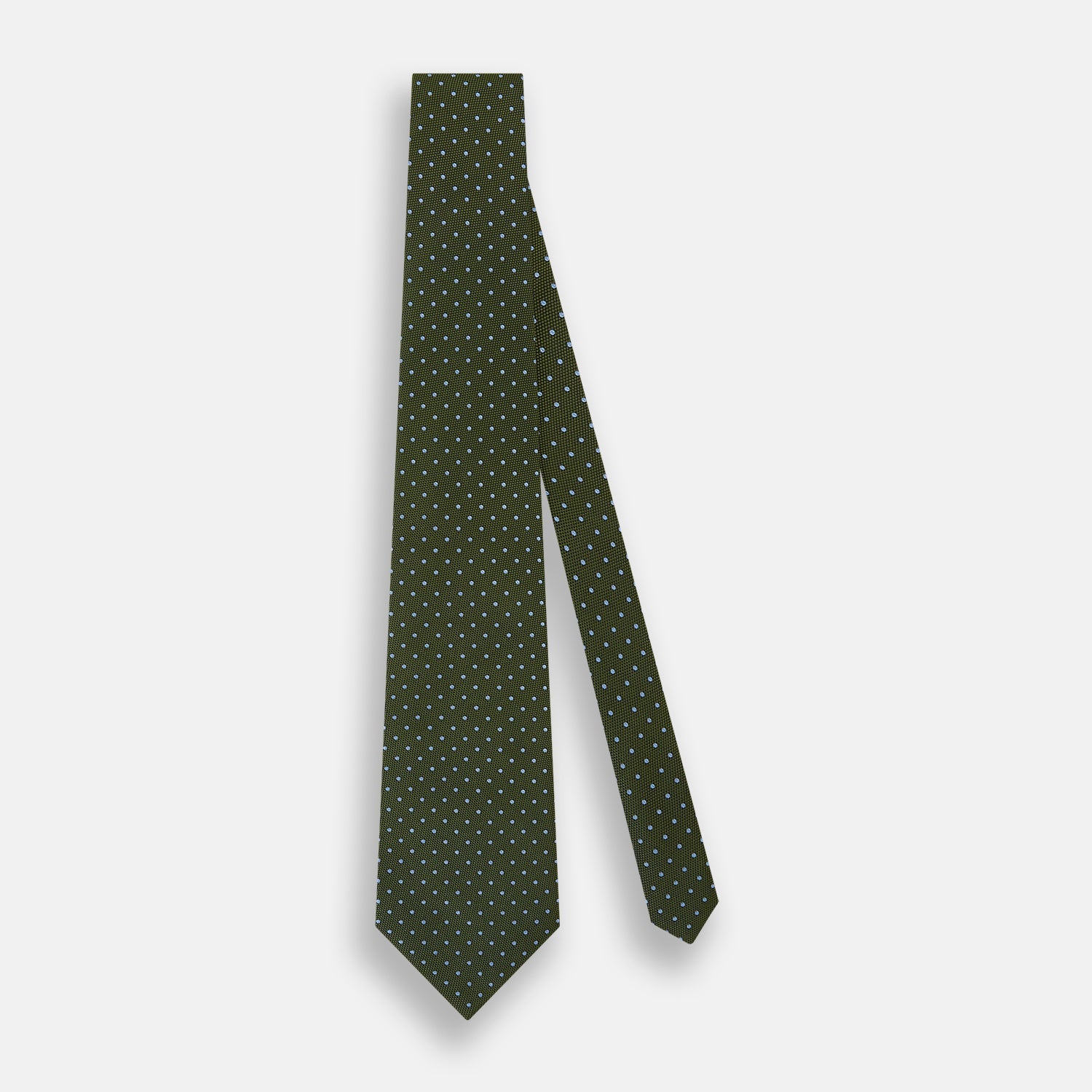 View 9 of product The Turnbull & Asser Green and Blue Micro Dot Silk Tie is shown rolled up, displaying small light blue dots on green silk against a plain white background.