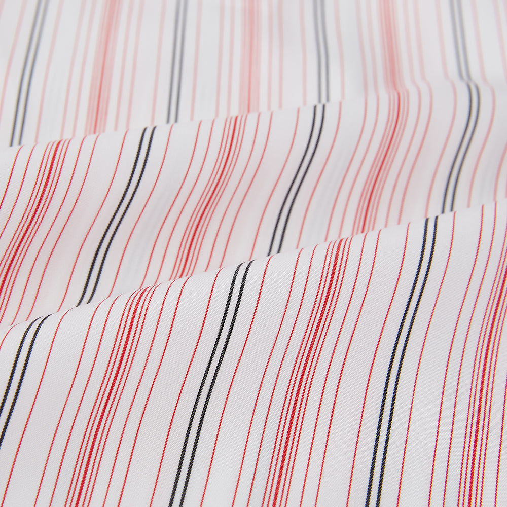 The Red Multi Pencil Stripe Windsor Shirt by Turnbull & Asser features long sleeves, buttoned cuffs, a Turnbull collar, and classic British tailoring with vertical red, pink, and white stripes.