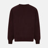 View 3 of product The Turnbull & Asser Burgundy Fine Merino V-Neck Jumper features a classic plain knit design with long sleeves, showcased against a crisp white background.
