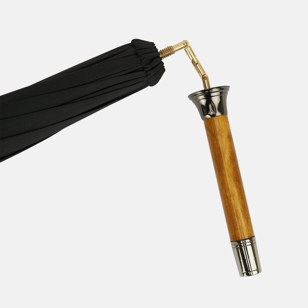 The Turnbull & Asser Black Traveller Umbrella features a Malacca crook handle and straight wooden shaft—a timeless accessory displayed fully opened against a white background.