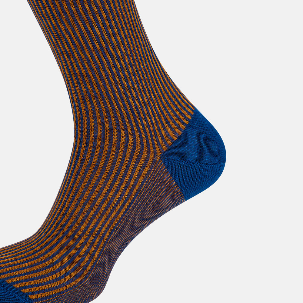 The Turnbull & Asser Royal Blue/Orange Thin Striped Long Sock is a knee-high, over-the-calf sock in mercerised Egyptian cotton, featuring vertical orange and dark blue stripes with blue cuff, heel, and toe. Displayed on a white background.