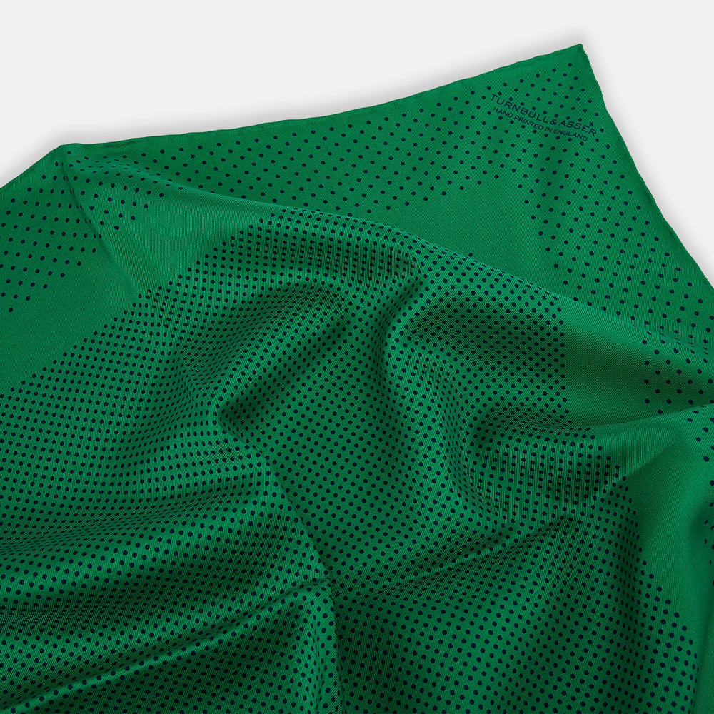 The Turnbull & Asser Green Dot Silk Pocket Square is handmade in England and shown neatly folded, revealing the front and part of the underside against a white background.
