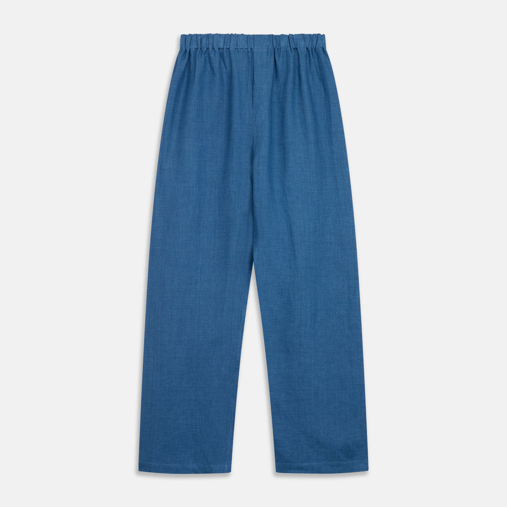 A person stands barefoot against a plain background, wearing the Teal Linen Modern Pyjama Set from Turnbull & Asser.