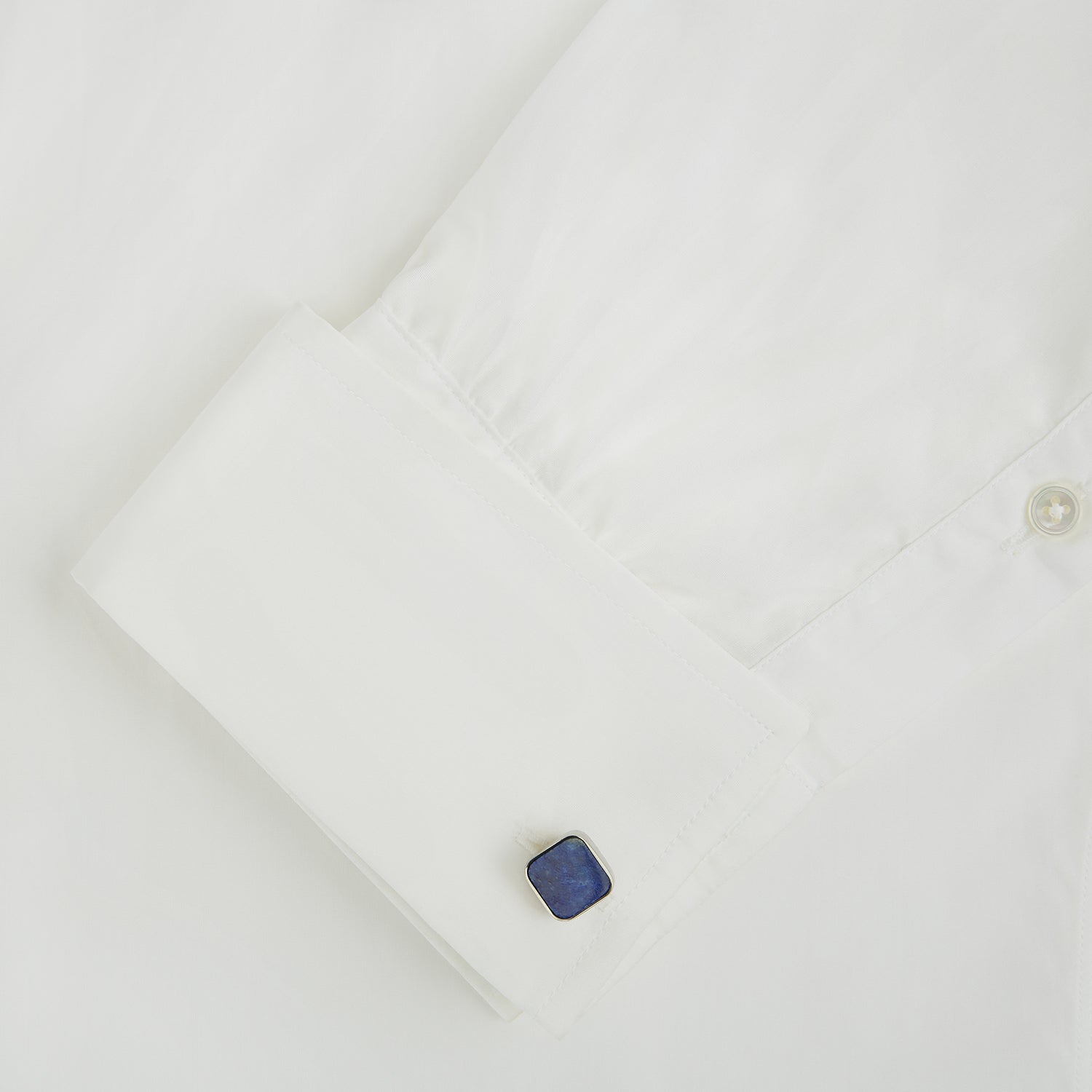 Image 3 of product Turnbull & Asser Lapis Lazuli Square Cufflinks feature sterling silver settings and vibrant blue lapis lazuli inlays with gold flecks, shown on a white background.