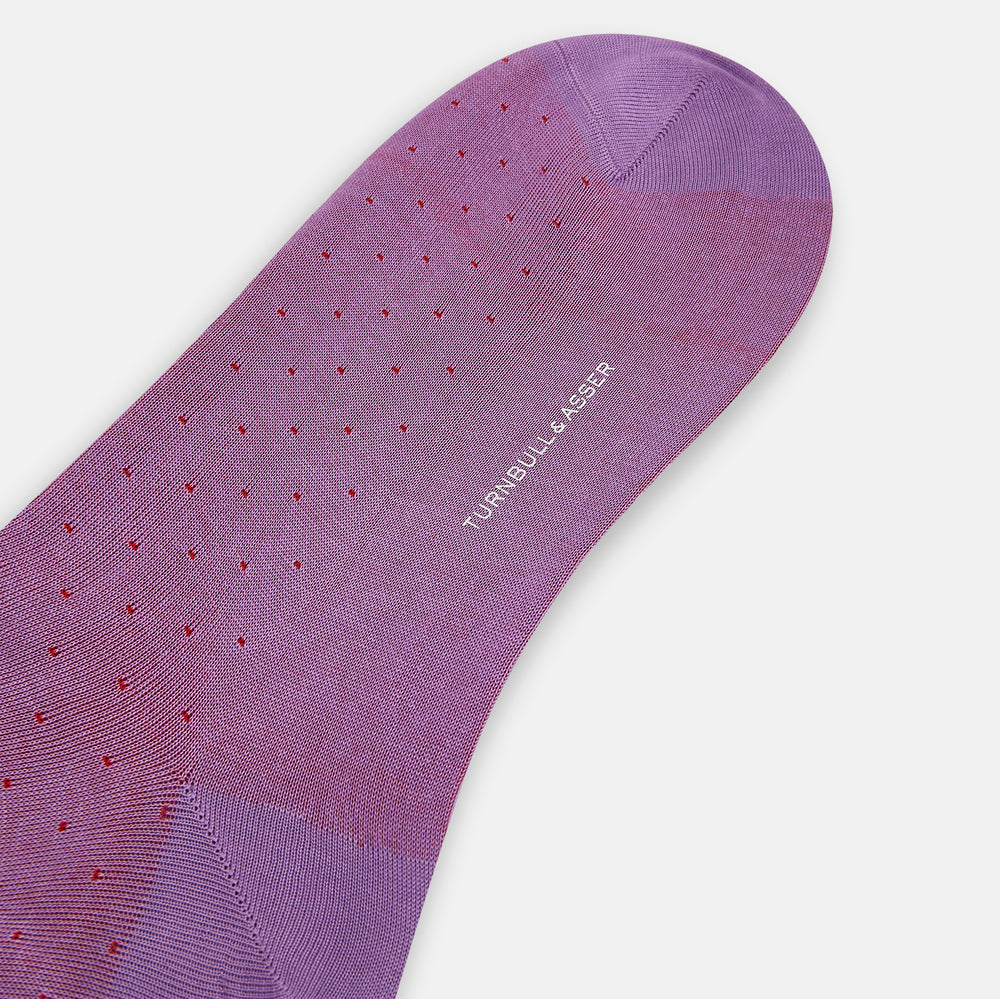 A single Pink/Red Polka Dot Long Sock by Turnbull & Asser, featuring a ribbed cuff and subtle red polka dots, is displayed against a plain white background.