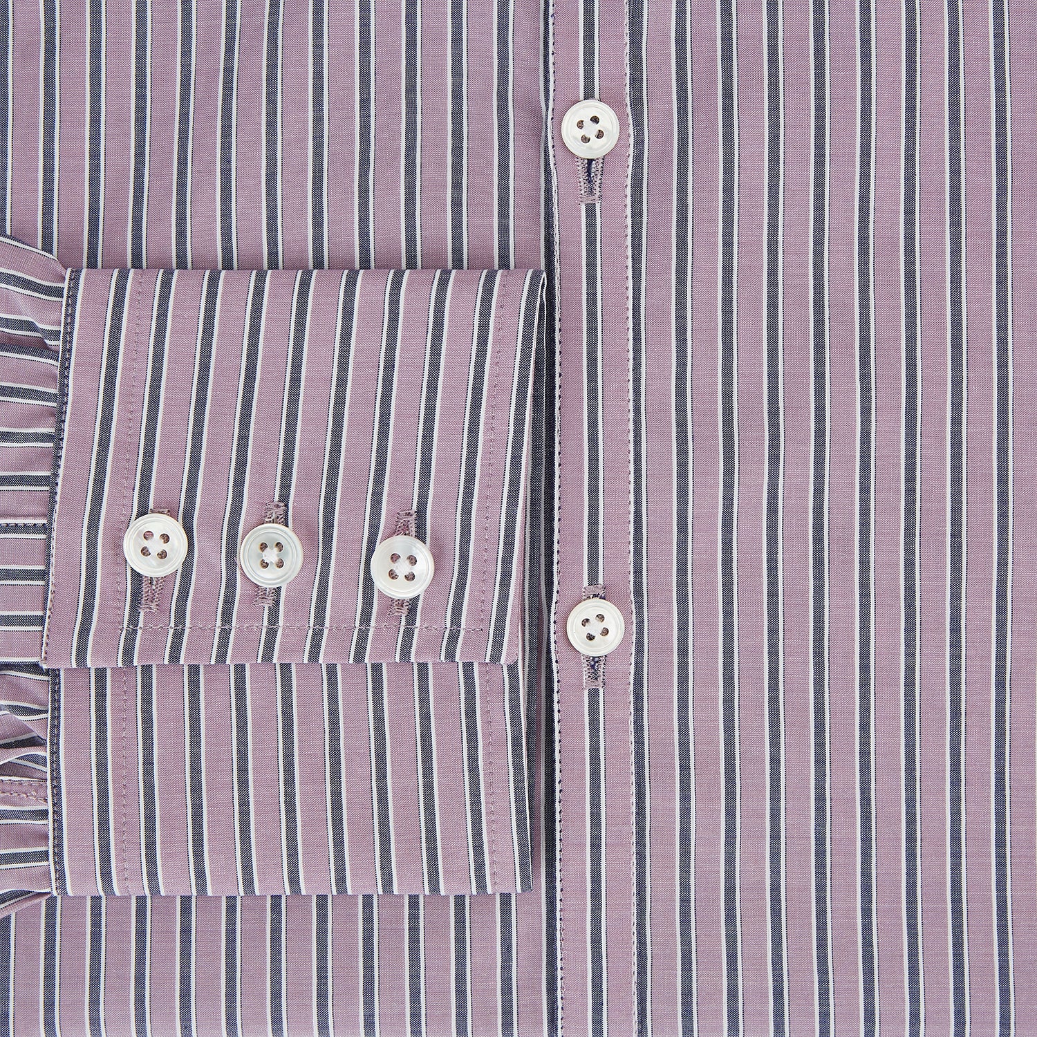 Image 4 of product The Turnbull & Asser Antique Pink Ticking Stripe Westminster Shirt is a collared, long-sleeve button-up with thin vertical pink stripes on white, highlighting British craftsmanship. It’s shown neatly laid flat and fully buttoned.
