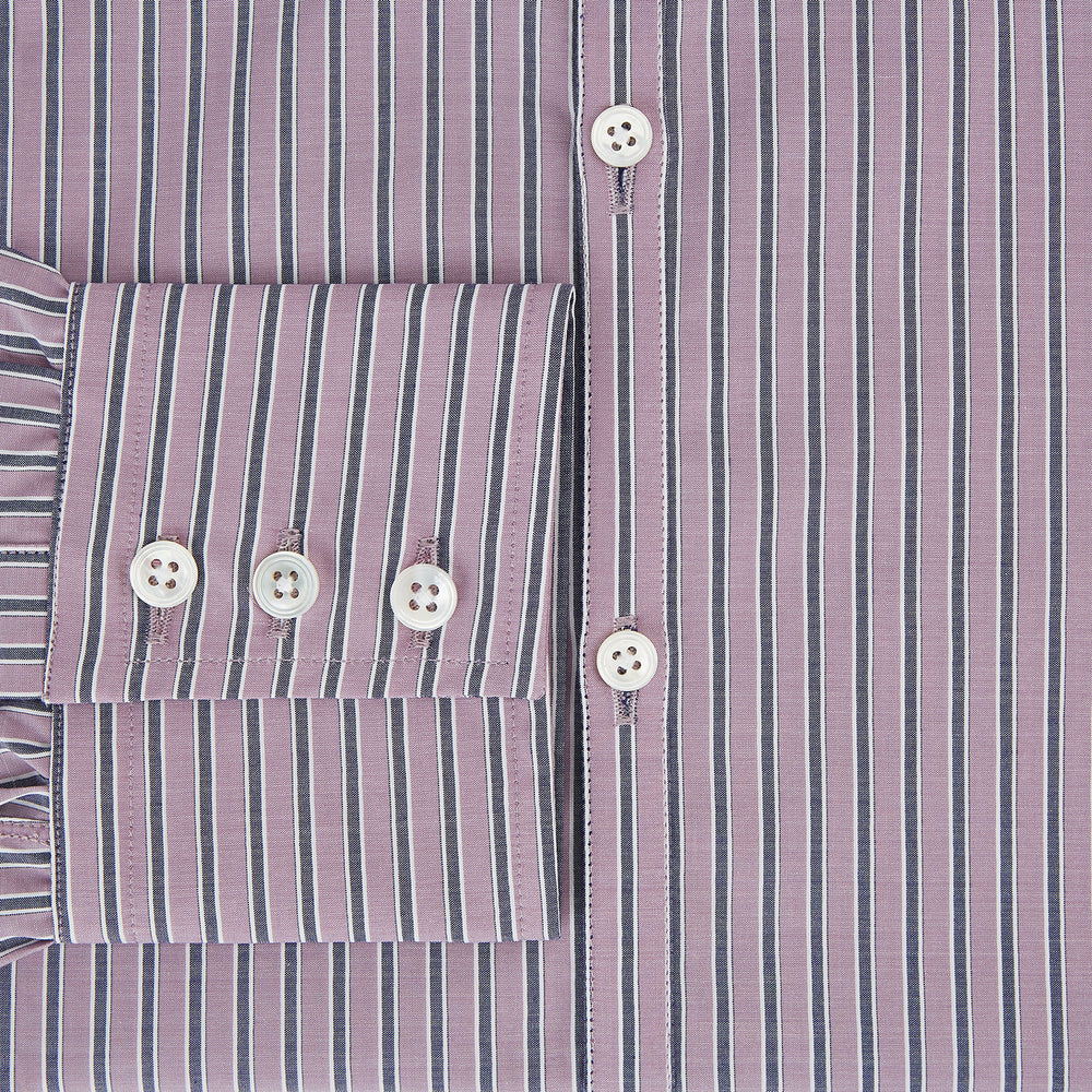 The Turnbull & Asser Antique Pink Ticking Stripe Westminster Shirt is a collared, long-sleeve button-up with thin vertical pink stripes on white, highlighting British craftsmanship. It’s shown neatly laid flat and fully buttoned.