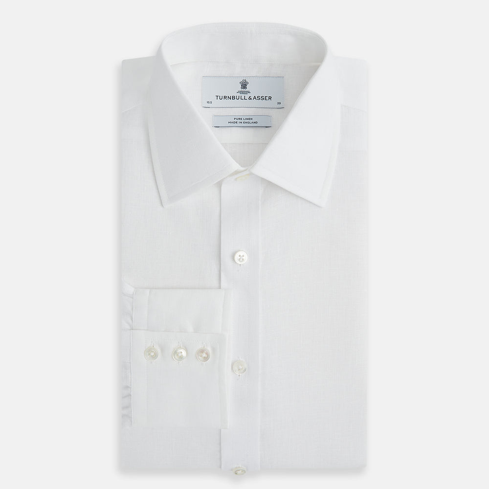 The Turnbull & Asser White Linen Mayfair Shirt features long sleeves and a classic collar, shown on a flat white background.