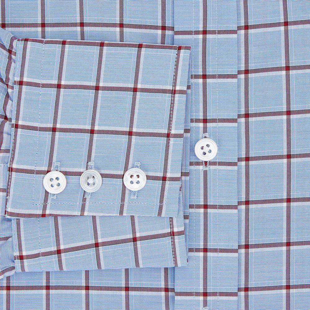The Turnbull & Asser Blue and Burgundy Windowpane Mayfair Shirt features long sleeves, a light blue base with burgundy windowpane checks, a classic collar, and white buttons.