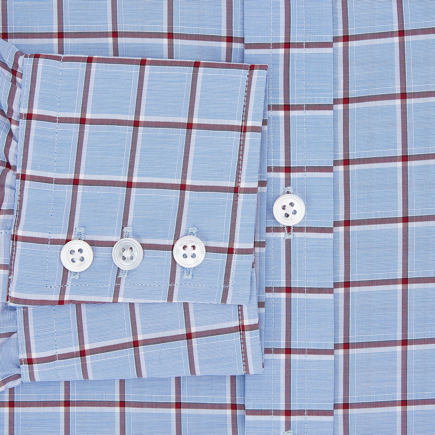 View 4 of product The Turnbull & Asser Blue and Burgundy Windowpane Mayfair Shirt features long sleeves, a light blue base with burgundy windowpane checks, a classic collar, and white buttons.
