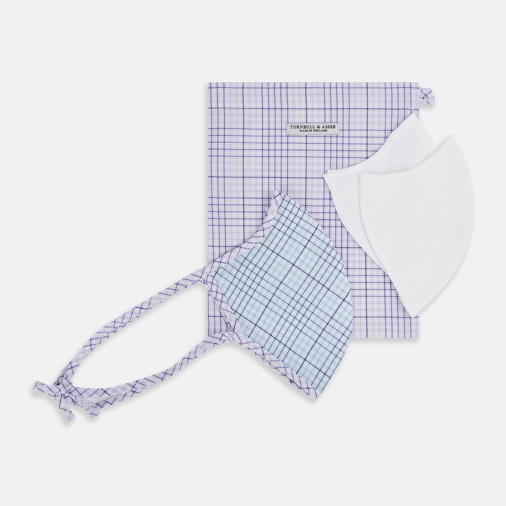 Introducing the Blue, Pink & Purple Checked Cotton Commuter Mask from Turnbull & Asser UK. This adjustable face covering features a vibrant checked pattern in blue, pink, and purple on soft cotton. The mask includes matching fabric straps finished with elegant bows at each end and comes with 3 VIROFORMULA™ filters for added protection.