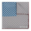 View 1 of product A geometric brown and blue silk pocket square from Turnbull & Asser UK, predominantly white with maroon and blue accents that suggest subtle burgundy tones, featuring a bold blue section in the top left corner and elegantly finished with the TURNBULL & ASSER branding in one corner.