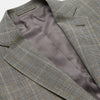 View 2 of product The Turnbull & Asser Beige Wool Prince-of-Wales Check Jacket is a single-breasted blazer with a notched lapel, one-button closure, two front flap pockets, and sleeve button details—an ideal lightweight summer jacket.