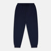 View 1 of product The Navy Cashmere Knitted Lounge Pyjama Trousers by Turnbull & Asser feature a contemporary fit, elastic waistband with drawstring, side pockets, and fitted cuffs, shown laid flat on a white background.