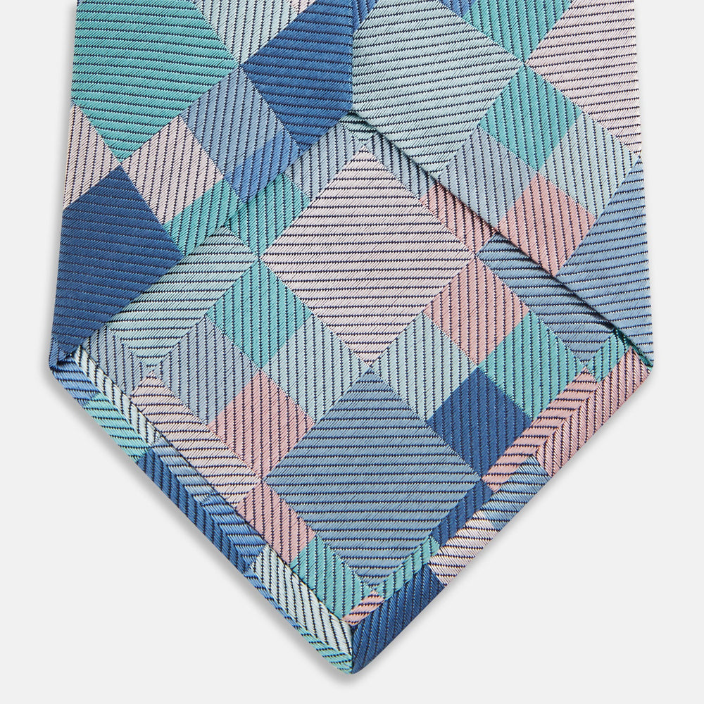 The Green Multi Pixel Silk Tie by Turnbull & Asser features a checked pattern in blue, teal, and pink on a light background, with diagonal stripes in each square for added texture.