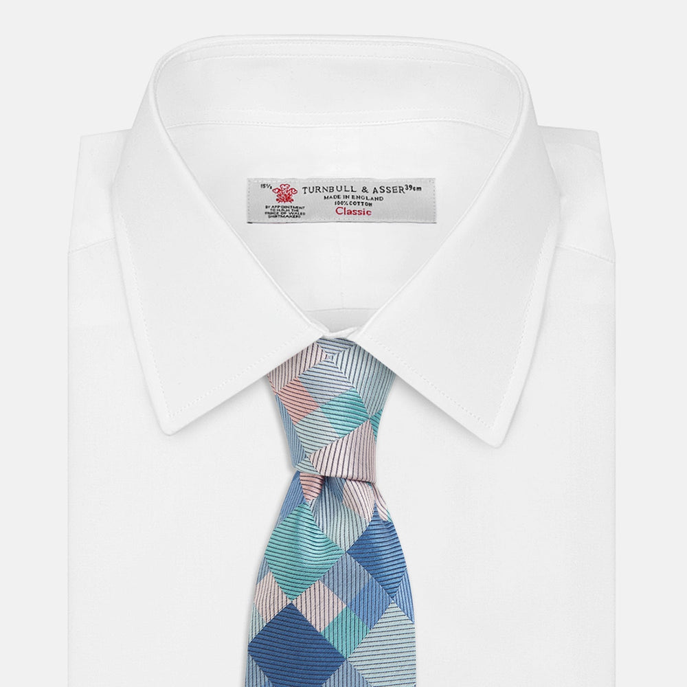 The Green Multi Pixel Silk Tie by Turnbull & Asser features a checked pattern in blue, teal, and pink on a light background, with diagonal stripes in each square for added texture.