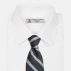 View 2 of product The Turnbull & Asser Blue & Silver Stripe Silk Tie, featuring wide diagonal stripes, is rolled up and displayed against a plain white background.
