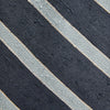 View 3 of product The Turnbull & Asser Blue & Silver Stripe Silk Tie, featuring wide diagonal stripes, is rolled up and displayed against a plain white background.