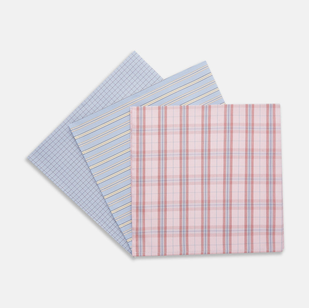 A set of three Turnbull & Asser Red and Blue Cotton RE-PURPOSE Handkerchiefs, neatly folded and tied with a blue and white striped ribbon, displayed against a white background.
