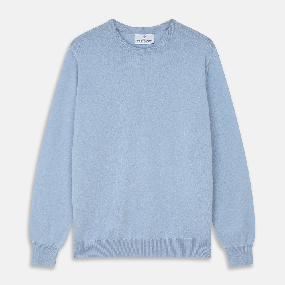 The Pale Blue Cashmere Glenn Jumper by Turnbull & Asser is laid flat against a white background. This men's crew neck essential features ribbed cuffs, hem, and neckline for timeless style.