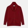 View 1 of product The Turnbull & Asser Burgundy Cashmere Ribbed Shawl Neck Ainsley Cardigan, featuring a button closure and two front pockets, is displayed flat on a white background.