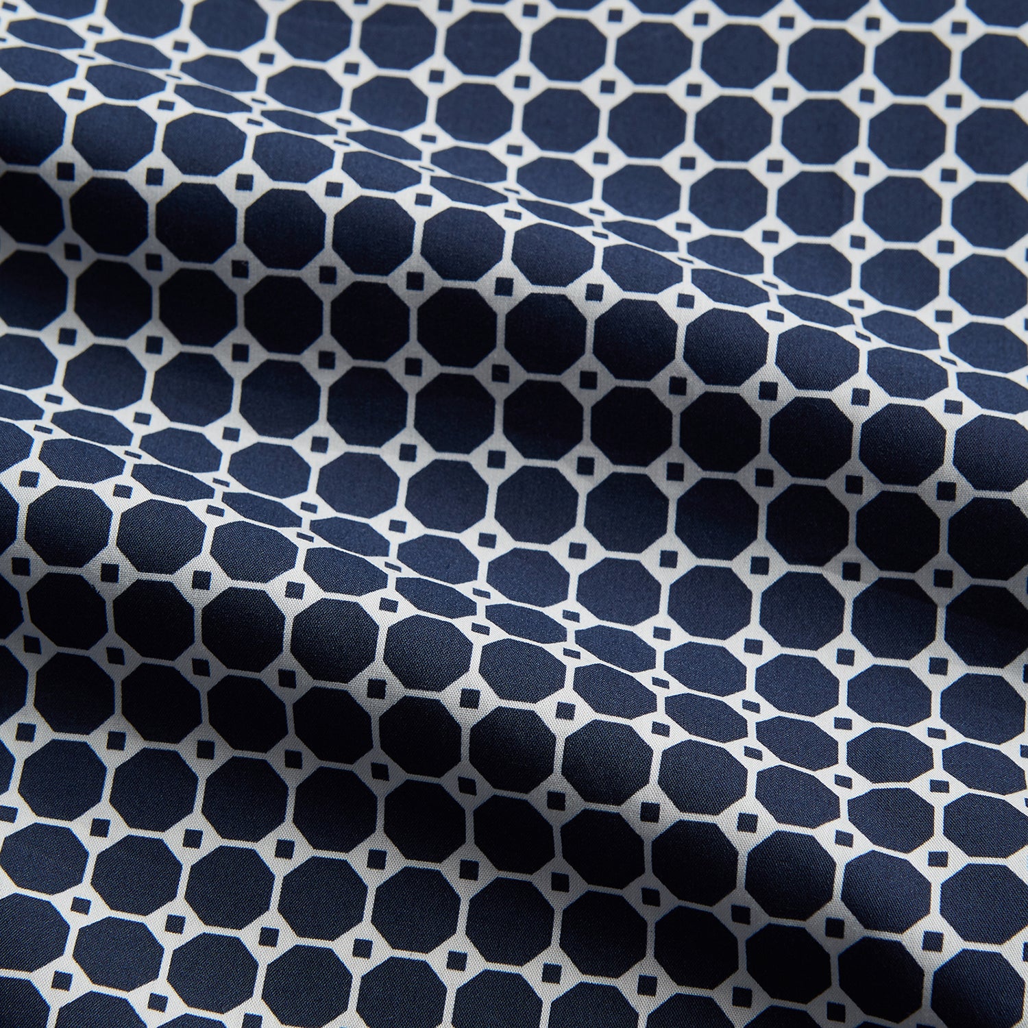 View 4 of product The Navy Motif Silk-Blend Hyde Pyjama Set by Turnbull & Asser features a blue and white pattern, long-sleeve button-up top with collar and front pocket, and matching pants, all displayed against a white background.