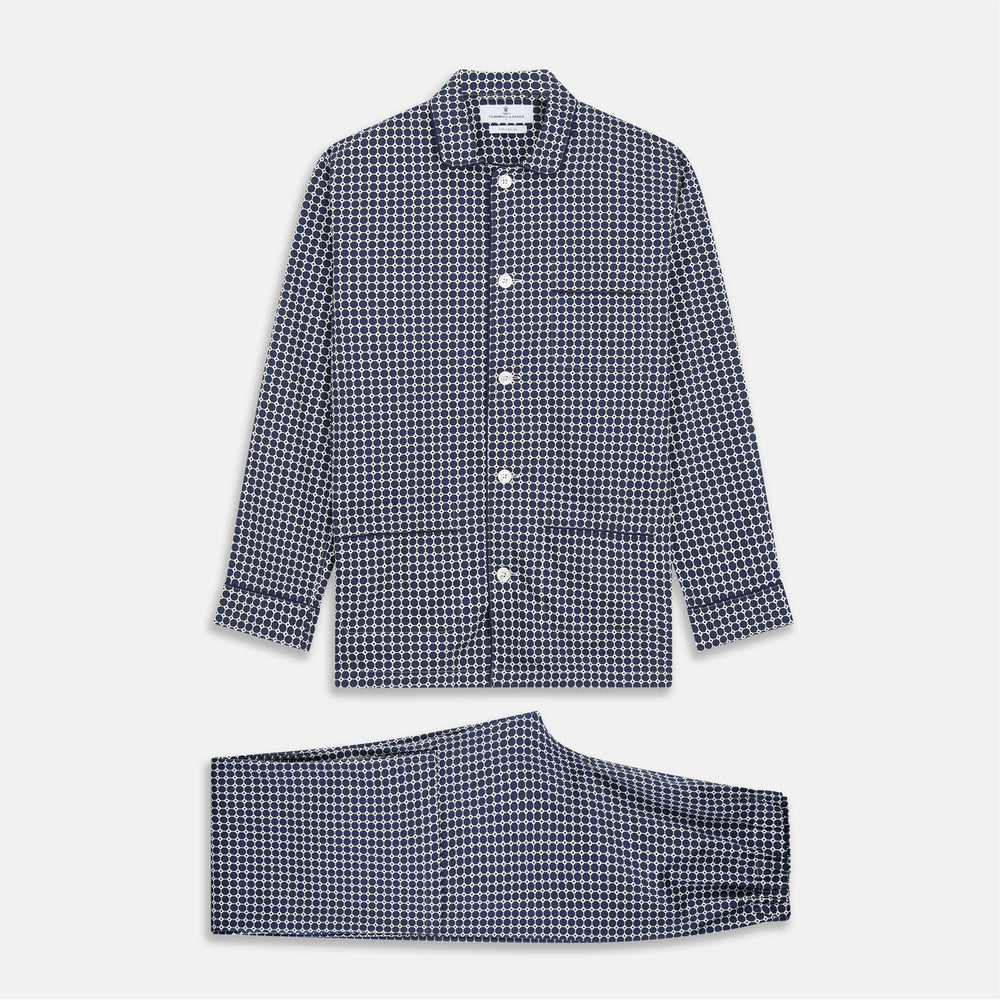 The Navy Motif Silk-Blend Hyde Pyjama Set by Turnbull & Asser features a blue and white pattern, long-sleeve button-up top with collar and front pocket, and matching pants, all displayed against a white background.