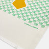 View 2 of product The Gold and Green Abstract Bird Silk Lawton Scarf by Turnbull & Asser features a white base with green checks, bold yellow Cubism-inspired bird motifs, and fringed edges, elegantly draped against a white background.