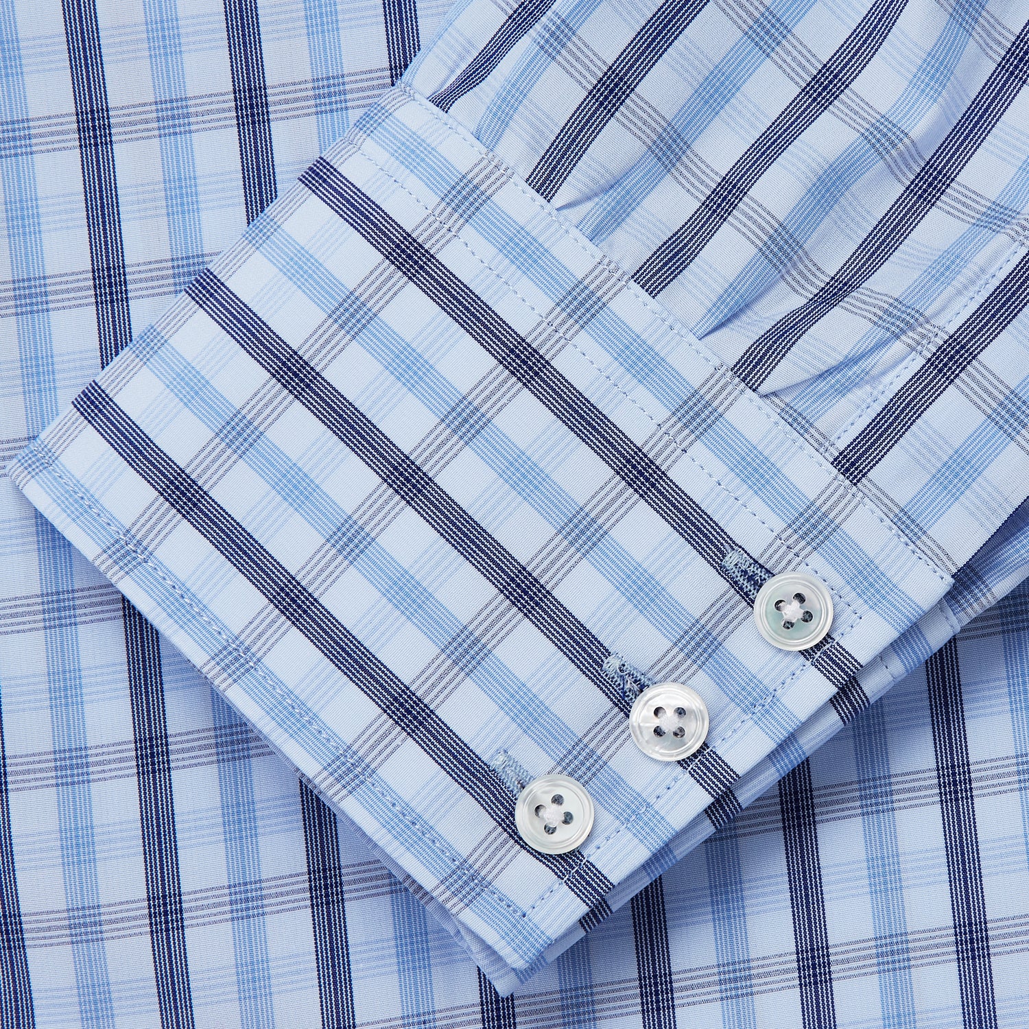 View 3 of product The Turnbull & Asser Light Blue and Navy Check Cotton Regular Fit Mayfair Shirt features a T&A collar and button-up long sleeves, displayed laid flat on a white background.